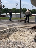 Escort driver and Sheriff's Deputy surveying the damage